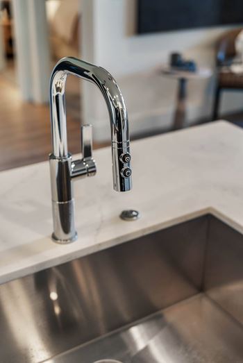 Quartz countertops in kitchen and baths with undermount sinks